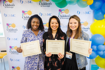 2023 - 2024 chief residents Drs. Liz Adeyemi, Breanna Lao, and India Hemphill accept their certificates.